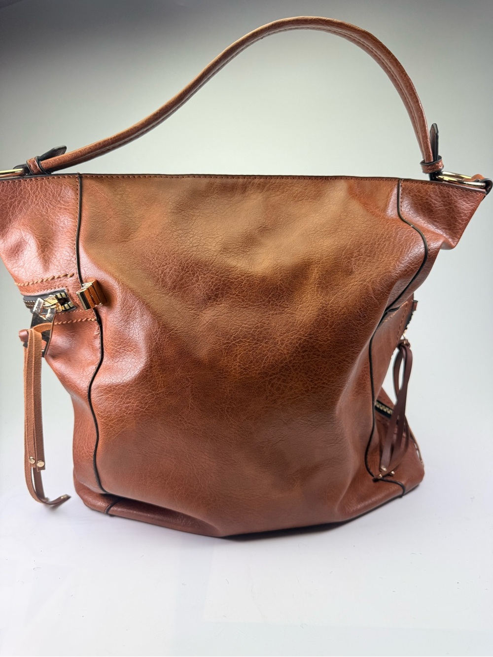Stylish brown vegan leather slouchy hobo bag featuring a relaxed shape